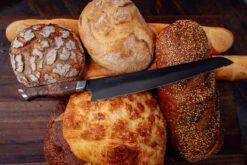 Steelport - 10" Carbon Steel Bread Knife - 65 HRC, Made In USA -Home Kitchen Store steelport 10 bread knife loaves 1600x1068 59712.1665153822